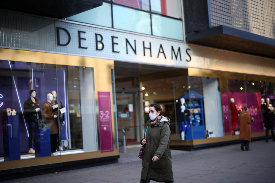 A woman walks past a Debenhams store on Oxford street in London, Britain, December 1, 2020. REUTERS/Henry Nicholls