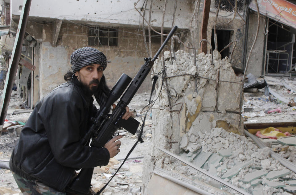 A rebel fighter from the Free Syrian Army holds a position with a Belgium made FAL rifle at a front line in the Salah al-Din neighbourhood of the northern Syrian city of Aleppo, on December 1, 2013. (MOHAMMED AL-KHATIEB/AFP/Getty Images)