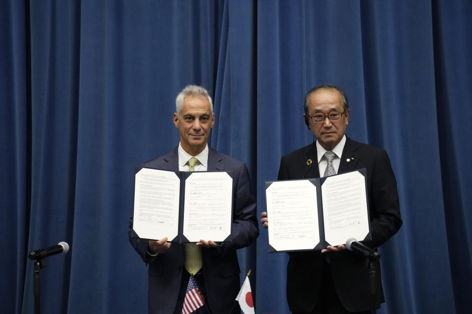 U.S. Ambassador to Japan Rahm Emanuel, left, and Hiroshima Mayor Kazumi Matsui show the documents they signed for a sister park arrangement between the Pearl Harbor National Memorial and the Hiroshima Peace Memorial Park at the U.S. Embassy Thursday, June 29, 2023 in Tokyo. (AP Photo/Eugene Hoshiko)