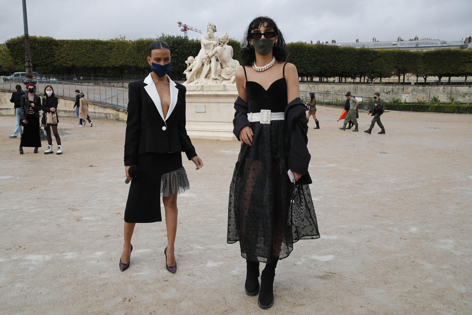 Fashion lovers strike a pose after Dior's Spring-Summer 2021 fashion collection presented Tuesday, Sept. 29, 2020 during the Paris fashion week. (AP Photo/Francois Mori)