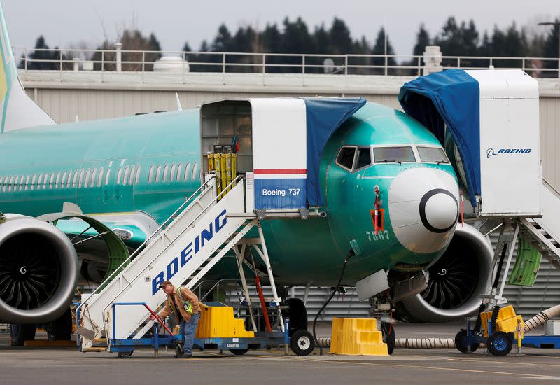 FILE PHOTO: An employee works near a Boeing 737 Max aircraft at Boeing's 737 Max production facility in Renton