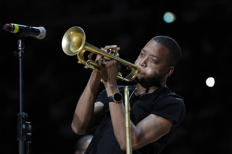 FILE - This March 14, 2012 file photo shows Troy "Trombone Shorty" Andrews performing at the half time of the New Orleans Hornets Los Angles Lakers NBA basketball game in New Orleans. Andrews and actor Gary Sinise will lead the parade of the Krewe of Orpheus on the evening of Lundi Gras, the day before Fat Tuesday. The celebrity riders were announced Thursday, Dec. 6, 2012, at Mardi Gras World, the huge studio where many Carnival floats are built. Orpheus marks its 20th anniversary when it parades Feb. 11. (AP Photo/Bill Haber)