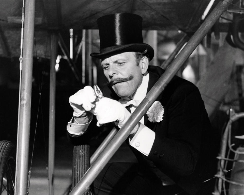 Sir Percy Ware-Armitage, played by English comic actor Terry-Thomas (1911 - 1990), sabotages a rival's aircraft in 'Those Magnificent Men In Their Flying Machines', directed by Ken Annakin, 1965. (Photo by Silver Screen Collection/Getty Images)