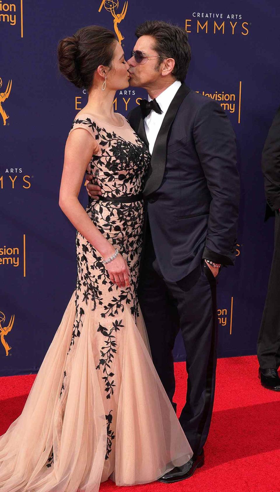 Caitlin McHugh and John Stamos attend the 2018 Creative Arts Emmy Awards at Microsoft Theater on September 8, 2018 in Los Angeles, California