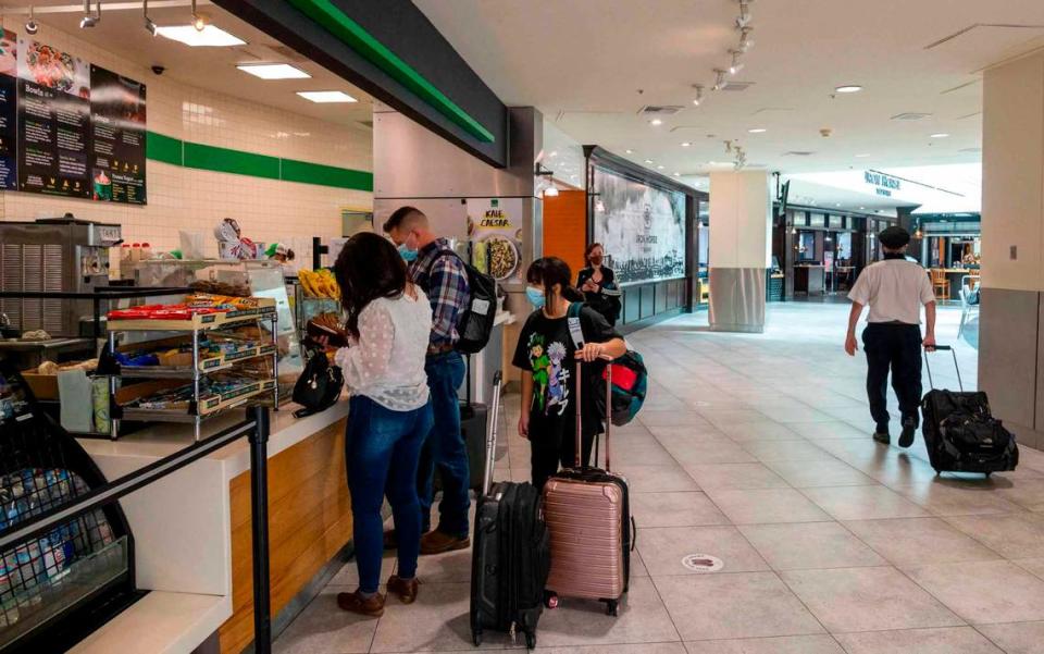 People purchase food in Terminal A in the Sacramento International Airport on Tuesday, October 26, 2021. There will be spaces for 18 eateries food concepts in both airport terminals as part of a remake of the airport’s concession program at the Sacramento International Airport. Officials plan farm-to-folk options, Asian eateries and more budget friendly choices.