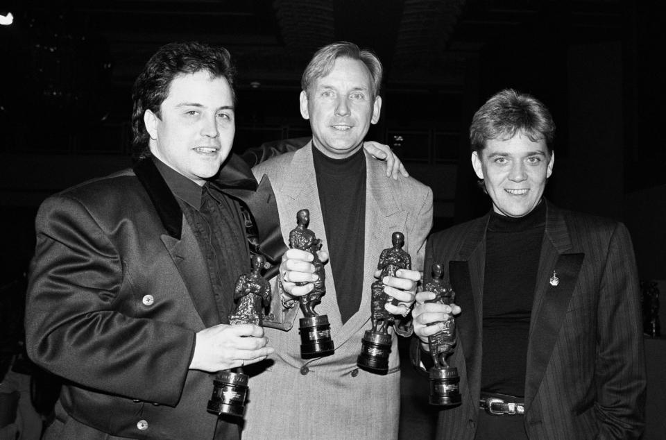 File photo dated 7/4/1988 of Matt Aitken, Pete Waterman and Mike Stock holding their Ivor Novello Award they received at London's Grosvenor House. The pop producers are set to reunite for a Channel 5 documentary, titled Stock Aitken Waterman: Step Back In Time, featuring interviews with Kylie Minogue, Rick Astley, Jason Donovan and Simon Cowell. The trio penned many of the enduring hits of the 1980s and 1990s, and helped launch the careers of some of music's biggest stars. Issue date: Monday December 12, 2022.