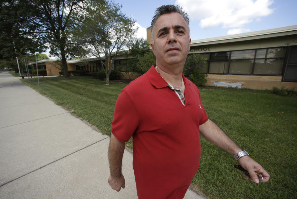 Jim Manna walks outside the former Eagle Elementary School in West Bloomfield, Mich., Wednesday, Aug. 29, 2012. This affluent Detroit suburb with a diverse mix of religions and races and center of the region's Jewish community is the latest battleground over mosque construction, as some residents push back against a school district's decision to sell a vacant elementary school to an Islamic group. The Farmington Hills school district defends its agreement to sell Eagle Elementary School to a Muslim association and an administrator says opposition now can be classified as "Islamophobia." (AP Photo/Paul Sancya)