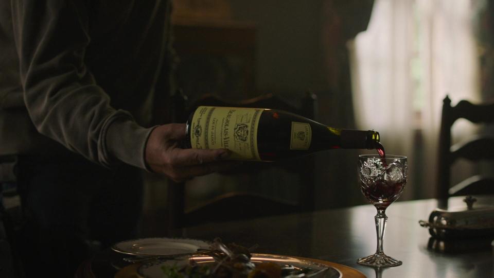 The bottle of wine being poured in a scene of "The Last of Us."