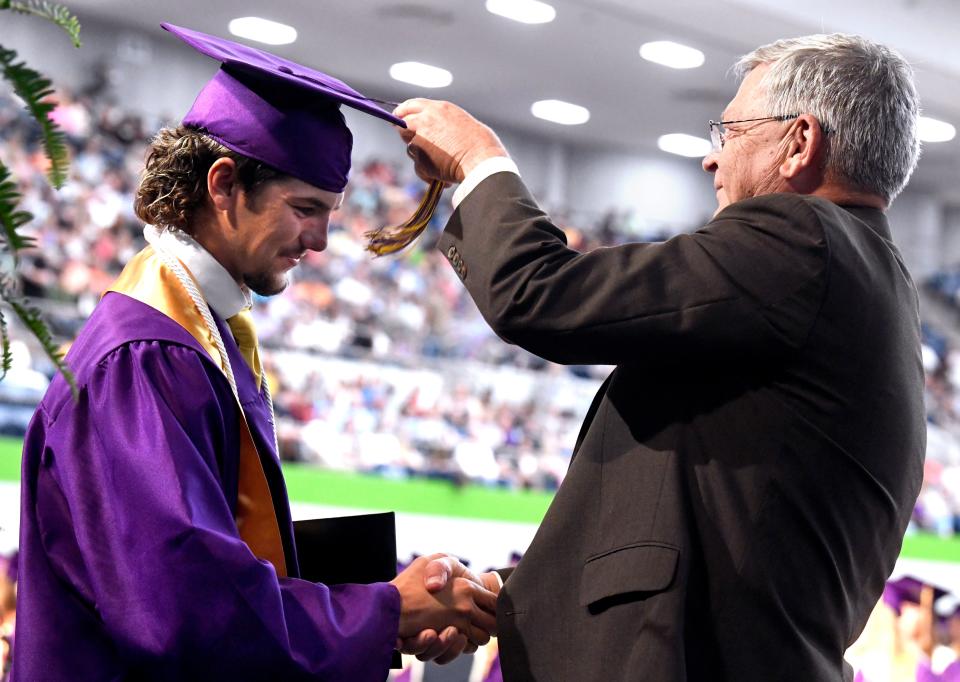 Wylie ISD Superintendent Joey Light congratulates Brady Clark and moves his tassel to Clark's left side, indicating that Clark has now graduated during Friday's commencement ceremony at the Taylor County Coliseum.