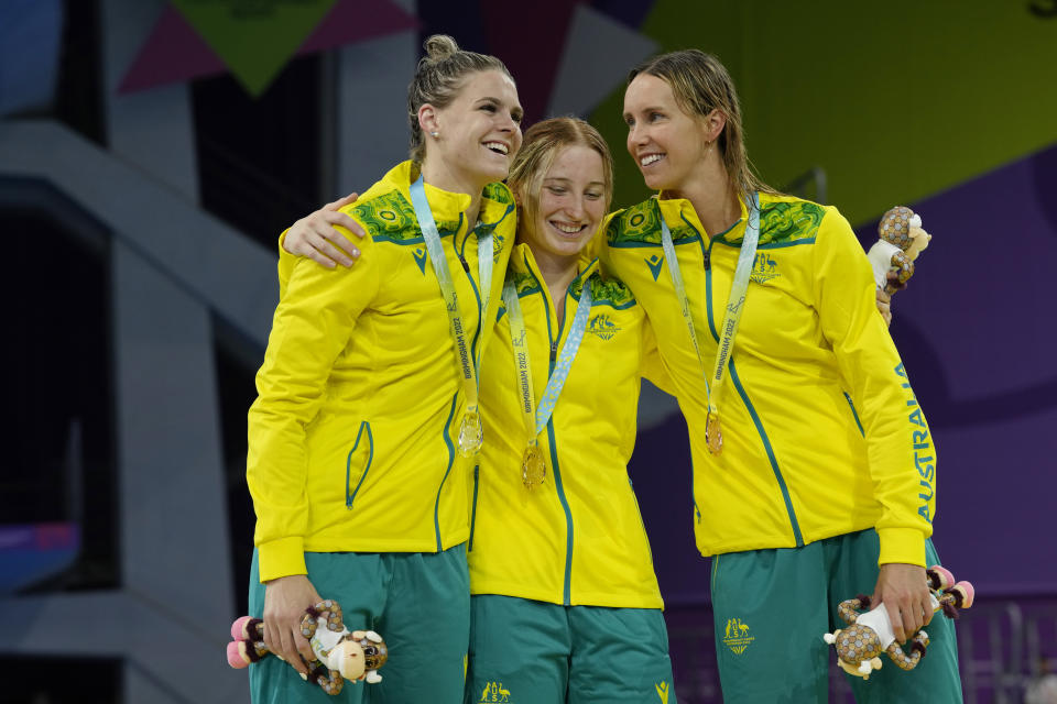 Australia's gold medalist Mollie O'Callaghan, centre, silver medalist Shayna Jack, left, and bronze medalist Emma McKeon celebrate during a medal ceremony for the Women's 100m Freestyle Final of the swimming competition at the Commonwealth Games, at the Sandwell Aquatics Centre in Birmingham, England, Tuesday, Aug. 2, 2022. (AP Photo/Kirsty Wigglesworth)