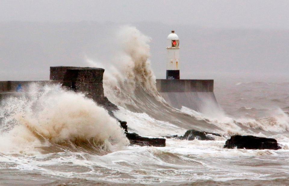 Huge waves crash against the sea wall at Porthcawl, south Wales (AFP via Getty Images)