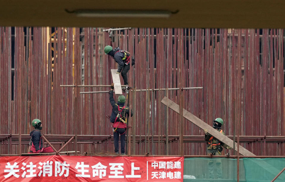 Vietnamese workers at the construction site of the first Chinese car tire factory in Europe near the northern Serbian town of Zrenjanin, 50 kilometers north of Belgrade, Serbia, Thursday, Nov. 18, 2021. Reports have emerged in Serbia of prison-like conditions for some 500 of them at the construction site in north of the country where China's Shandong Linglong Tire Co is building the huge factory. Populist-run Serbia is a key spot for China's expansion and investment policies in Europe and Chinese companies have kept a tight lid on their projects in the country amid reports of disrespect of the Balkan nation's anti-pollution laws and labor regulations. (AP Photo/Darko Vojinovic)