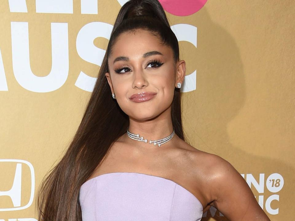 FILE - In this Dec. 6, 2018 file photo, Ariana Grande attends the 13th annual Billboard Women in Music event in New York. Grammys producer Ken Ehrlich says the show had multiple conversations with Grande about performing at the awards show on Sunday but the singer “felt it was too late for her to pull something together.” (Photo by Evan Agostini/Invision/AP, File)