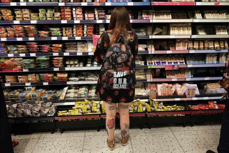 A person looks at food goods in a shop in London