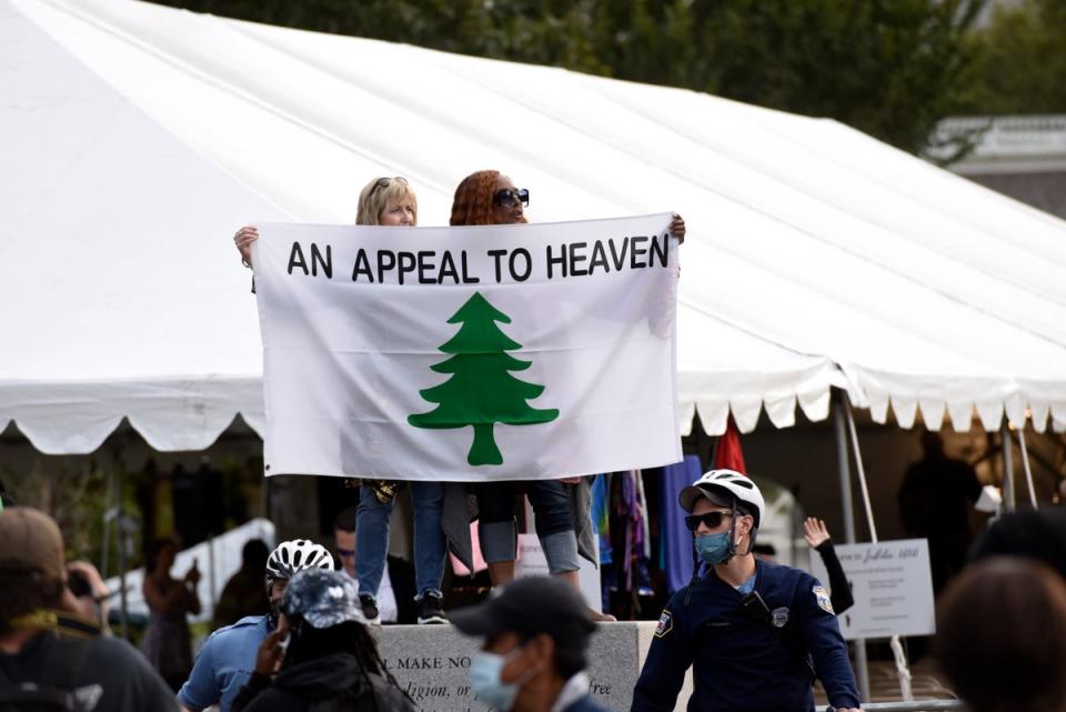 People carry an ‘Appeal To Heaven’ flag as they gather at Independence Mall to support President Donald Trump during a visit to the National Constitution Center to participate in the ABC News town hall, September 15, 2020, in Philadelphia (AP)