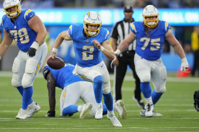 Los Angeles Chargers quarterback Easton Stick (2) carries for a gain in the second half.