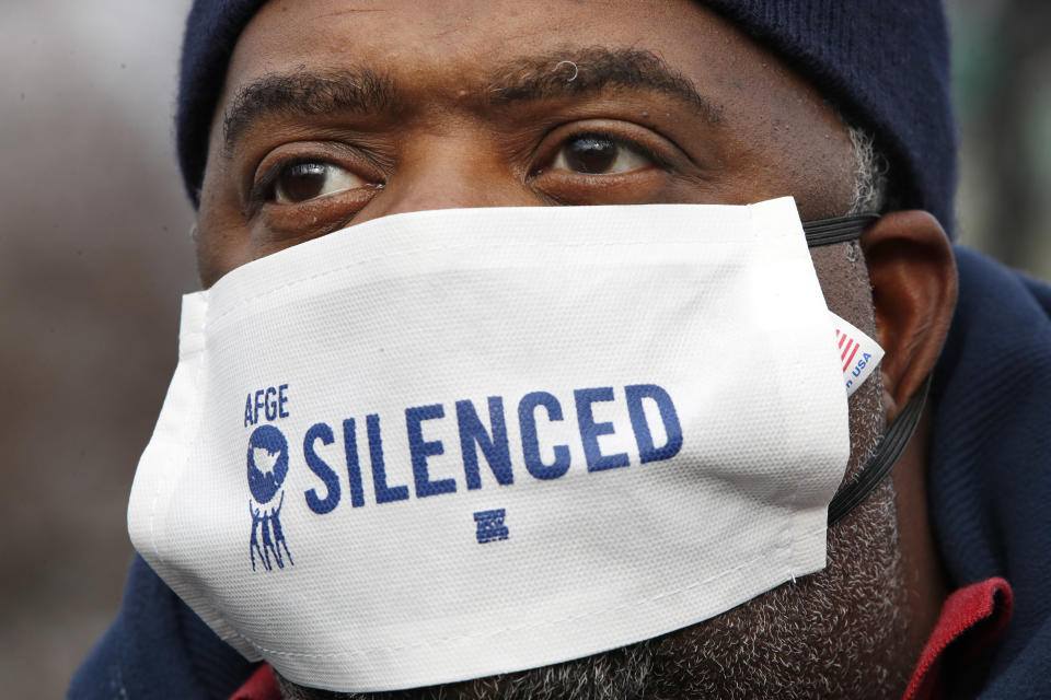 FILE - Wearing a mask that says "silenced," Appollos Baker, with the American Federation of Government Employees, rallies outside the Supreme Court in opposition to Ohio's voter roll purges in Washington, in Jan. 18, 2018. A U.S. Supreme Court decision a decade ago that tossed out the heart of the Voting Rights Act continues to reverberate across the country. Republican-led states continue to pass voting restrictions that, in several cases, would have been subject to federal review had the court left the provision intact. (AP Photo/Jacquelyn Martin, File)