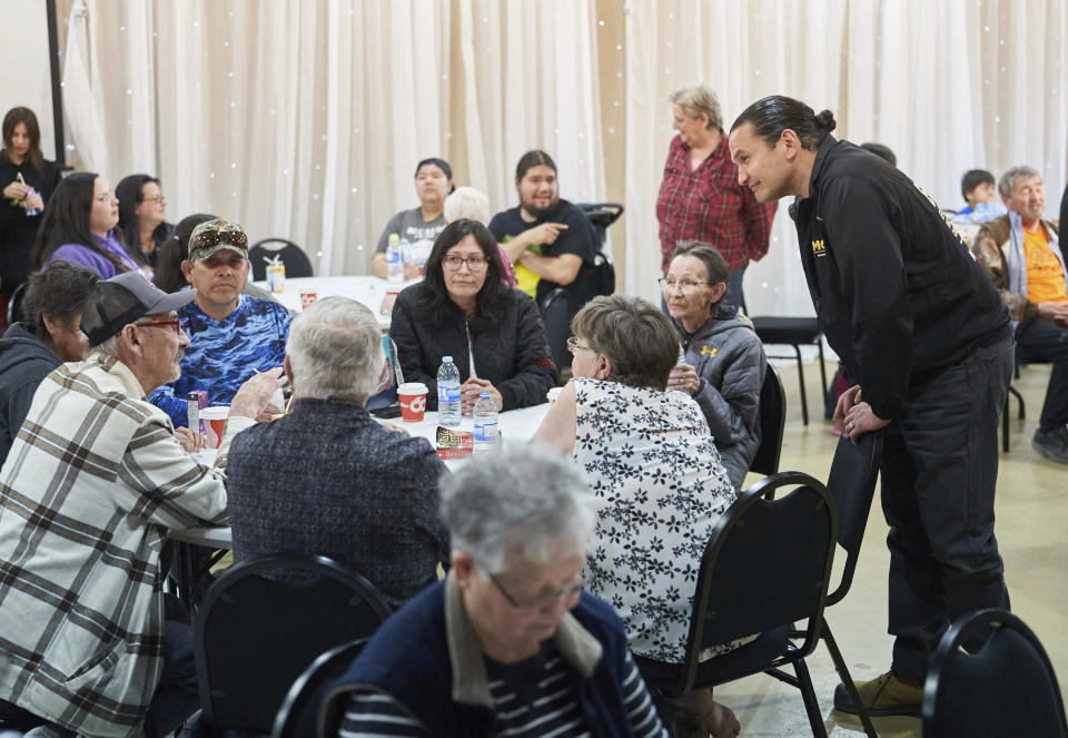 Manitoba Premier Wab Kinew speaks with evacuees from the Cranberry Portage area at the reception centre at the Wescana Inn in The Pas, Man., as wildfires burn in northern Manitoba, Tuesday, May 14, 2024. (David Lipnowski/The Canadian Press via AP)