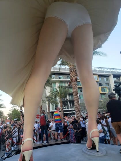 People mill around the base of "Forever Marilyn," the 26-foot tall Marilyn Monroe statue dedicate in Palm Springs on June 20