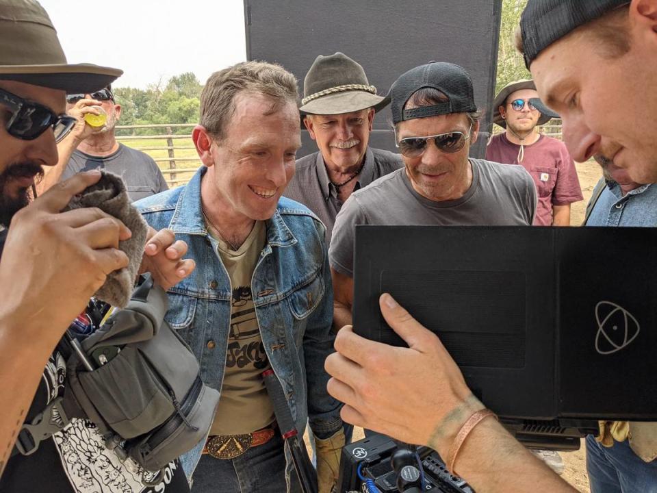 Jay Pickett, center in sunglasses, reviews takes from his film “Treasure Valley” as director Travis Mills, in denim jacket, and Canyon County Sheriff Kieran Donahue, in cowboy hat, look on. Pickett died while filming “Treasure Valley,” which he wrote and starred in.