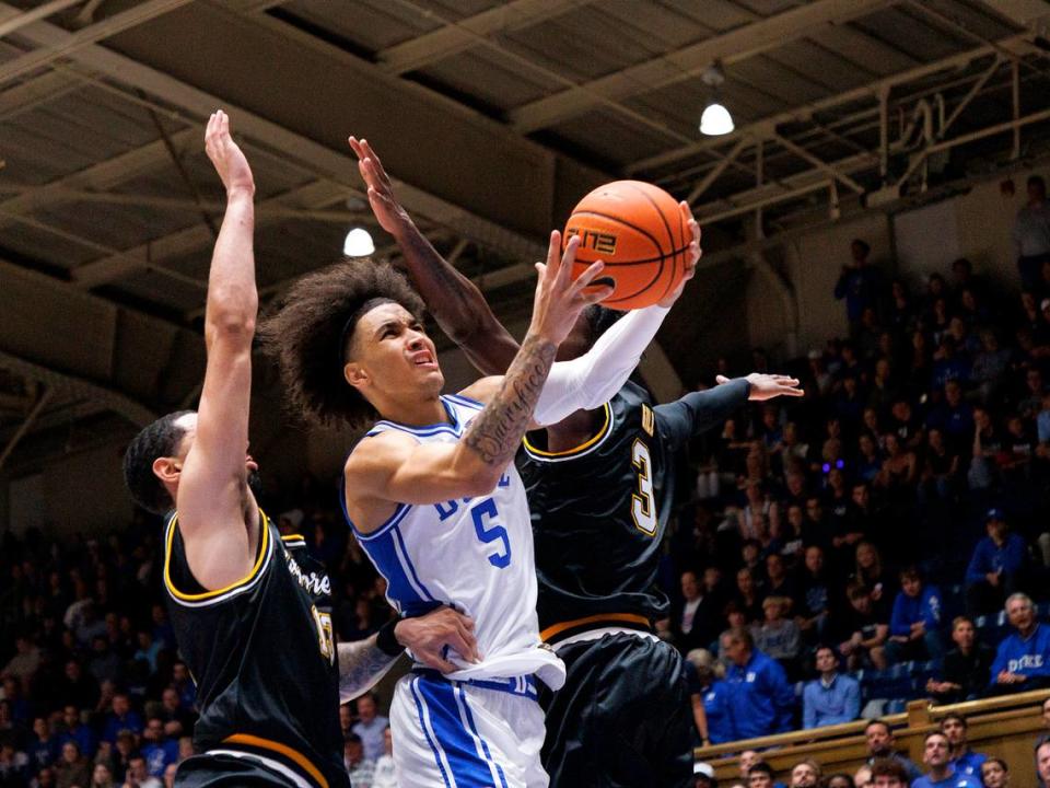 Duke’s Tyrese Proctor drives between La Salle’s Daeshon Shepherd and Anwar Gill during the first half of the Blue Devils’ game on Tuesday, Nov. 21, 2023, at Cameron Indoor Stadium in Durham, N.C.