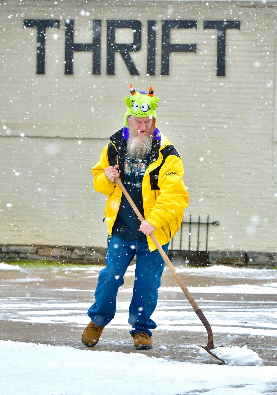 Howard Hawkins shovels snow Wednesday outside the Rescue Mission Thrift Store on Church Street in Hagerstown. A winter storm dropped a few inches on the region, from West Virginia's Eastern Panhandle into South-central Pennsylvania. Forecasters are saying 40 mph winds are expected Thursday.