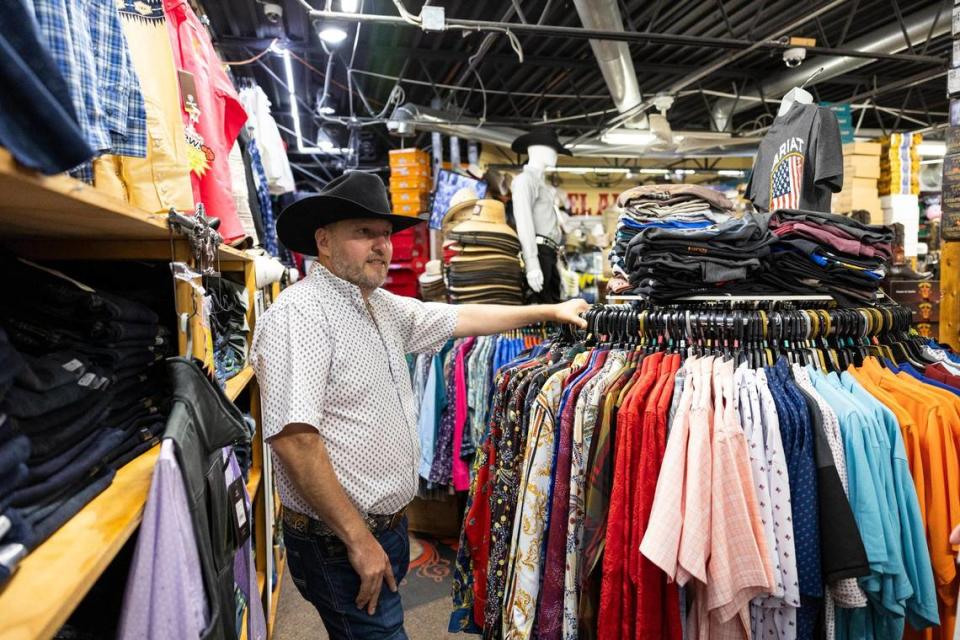 Cesar Ramirez, owner of El Alazan Western Wear, greets customers in his shop in Cardinal Valley off Alexandria Drive in Lexington, Ky., Friday, July 28, 2023.