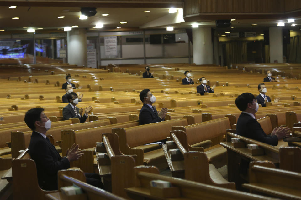 Pastors wearing face masks attend a service at the Yoido Full Gospel Church in Seoul, South Korea, Sunday, March 15, 2020. The church decided to replace Sunday services with online ones for members' safety amid the spread of the new coronavirus. For most people, the new coronavirus causes only mild or moderate symptoms. For some it can cause more severe illness. (AP Photo/Ahn Young-joon)