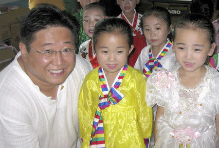 Kenneth Bae, with North Korean Children, is pictured in this undated family handout photo courtesy of freekennow.com. REUTERS/freekennow.com/Handout