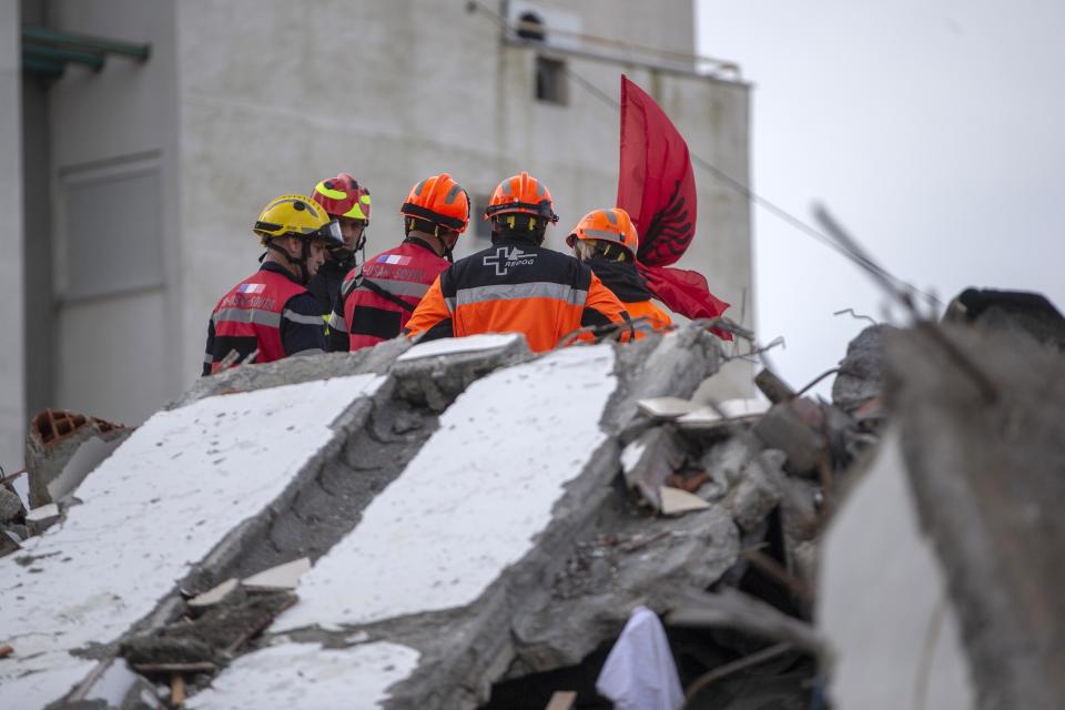In this photo taken on Friday, Nov. 29, 2019, rescuers from France and Switzerland operate at a collapsed building after the 6.4-magnitude earthquake in Durres, western Albania. In the initial hours after a deadly pre-dawn earthquake struck Albania, pancaking buildings and trapping dozens of sleeping people beneath the rubble, the country’s neighbors sprang into action. Offers of help flooded in from across Europe and beyond, with even traditional foes setting aside their differences in the face of the natural disaster. The 6.4-magnitude earthquake that struck Albania on Tuesday killed at least 49 people, injured 2,000 and left at least 4,000 homeless. (AP Photo/Visar Kryeziu)