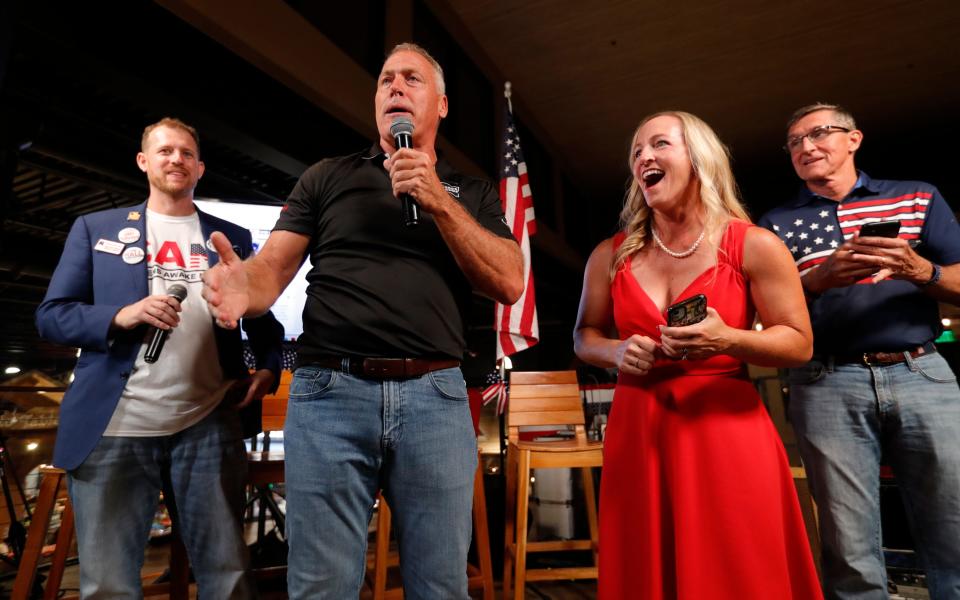 Alfie Oakes, second from left, stands alongside Daniel Francis Cook, to his left, school board district 3 candidate Kelly Lichter, and retired Lt. Gen. Michael Flynn while addressing the crowd during an election results watch party at Seed to Table in Naples Tuesday November 8, 2022. 