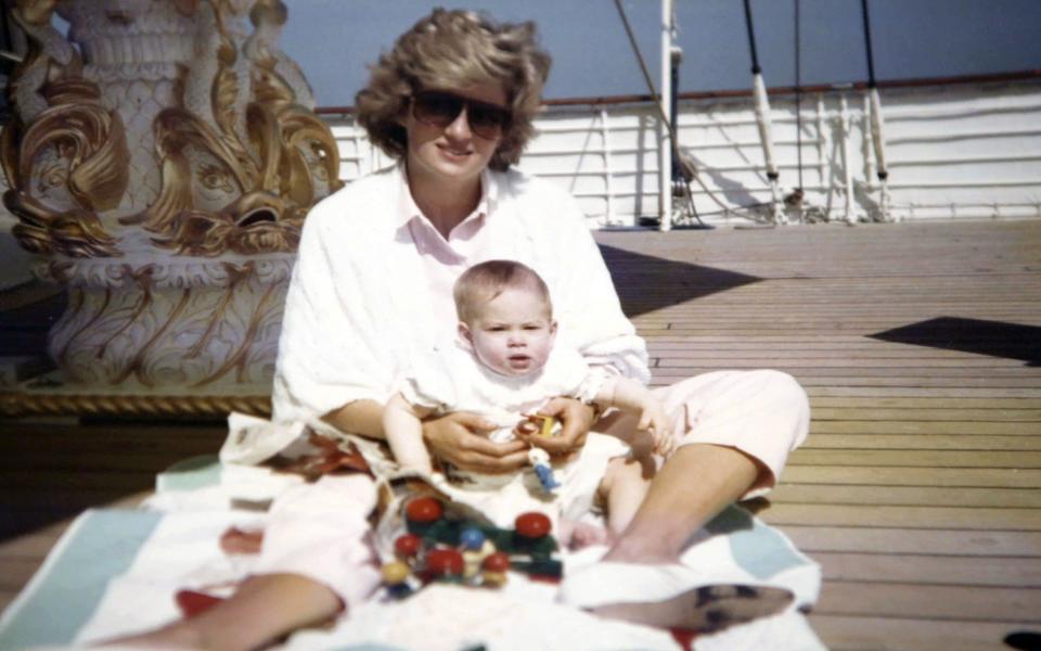 Diana, Princess of Wales, holds Prince Harry on the Royal Yacht Britannia in a picture taken by Prince William - Credit: The Duke of Cambridge and Prince Harry