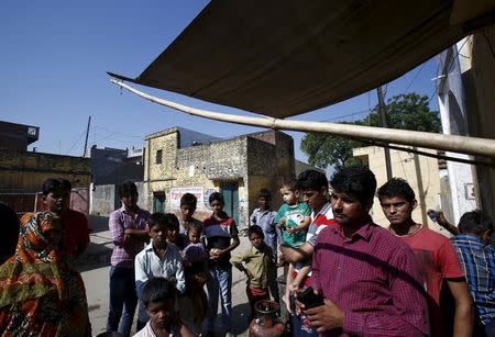 Local residents stand outside a temple at Bisara village in Uttar Pradesh, India, October 2, 2015. REUTERS/Anindito Mukherjee