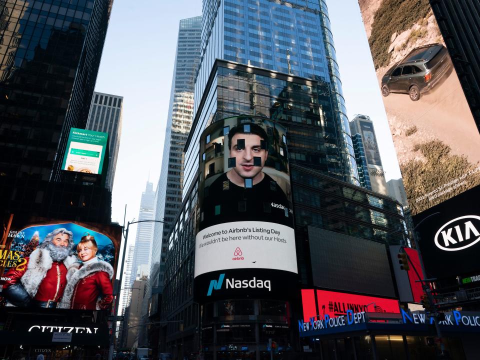 Digital billboards in Times Square, one with Brian Chesky's face projected