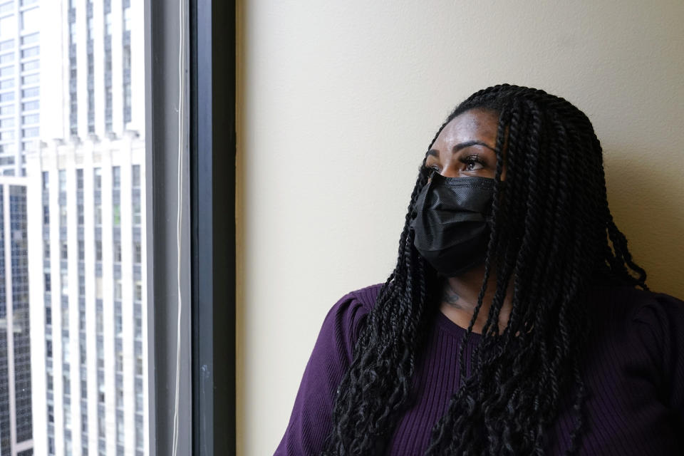 In this Sept. 23, 2021, photo Domonique Wilson looks outside from her attorney's office in Chicago. Wilson’s son Royal Smart was handcuffed by police in south Chicago as part of a raid on his home when he was 8-years-old. Police were looking for illegal weapons and found none. No one was arrested. Wilson, said her children still sleep with the lights on all night. They continue to try therapy but she said the memories still torment them. (AP Photo/Nam Y. Huh)