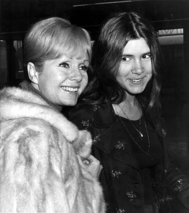 Actress Debbie Reynolds, left, and her daughter Carrie Fisher, 15, en route to Madrid at Heathrow Airport in London, England, Feb. 12, 1972. (AP Photo)