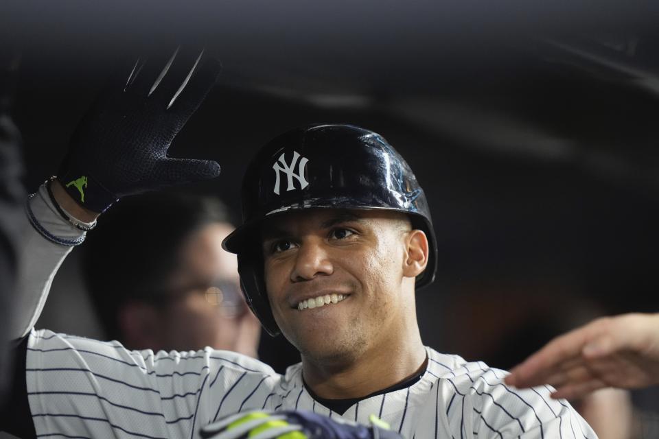 New York Yankees' Juan Soto smiles in the dugout after hitting a home run against the Seattle Mariners during the sixth inning of a baseball game Wednesday, May 22, 2024, in New York. (AP Photo/Frank Franklin II)