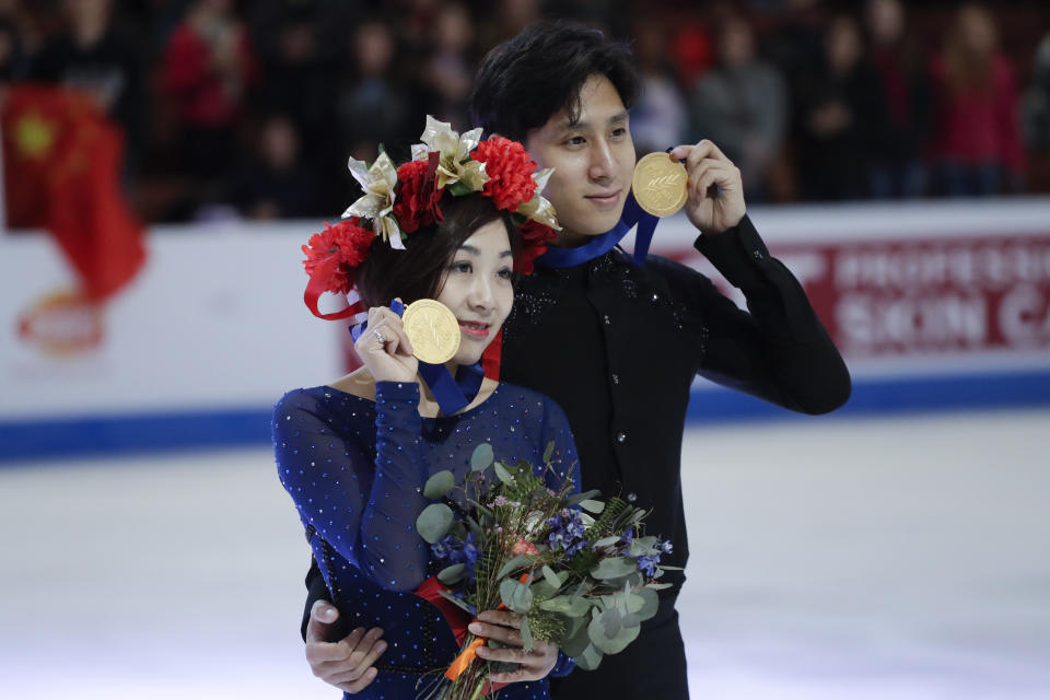 Wenjing Sui and Cong Han, of China, hold their gold medals after winning the pairs competition at the Four Continents Figure Skating Championships on Saturday, Feb. 9, 2019, in Anaheim, Calif. (AP Photo/Chris Carlson)