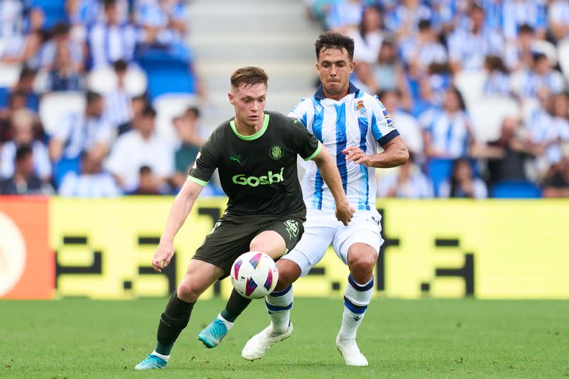 Martin Zubimendi of Real Sociedad duels for the ball with Viktor Tsygankov of Girona