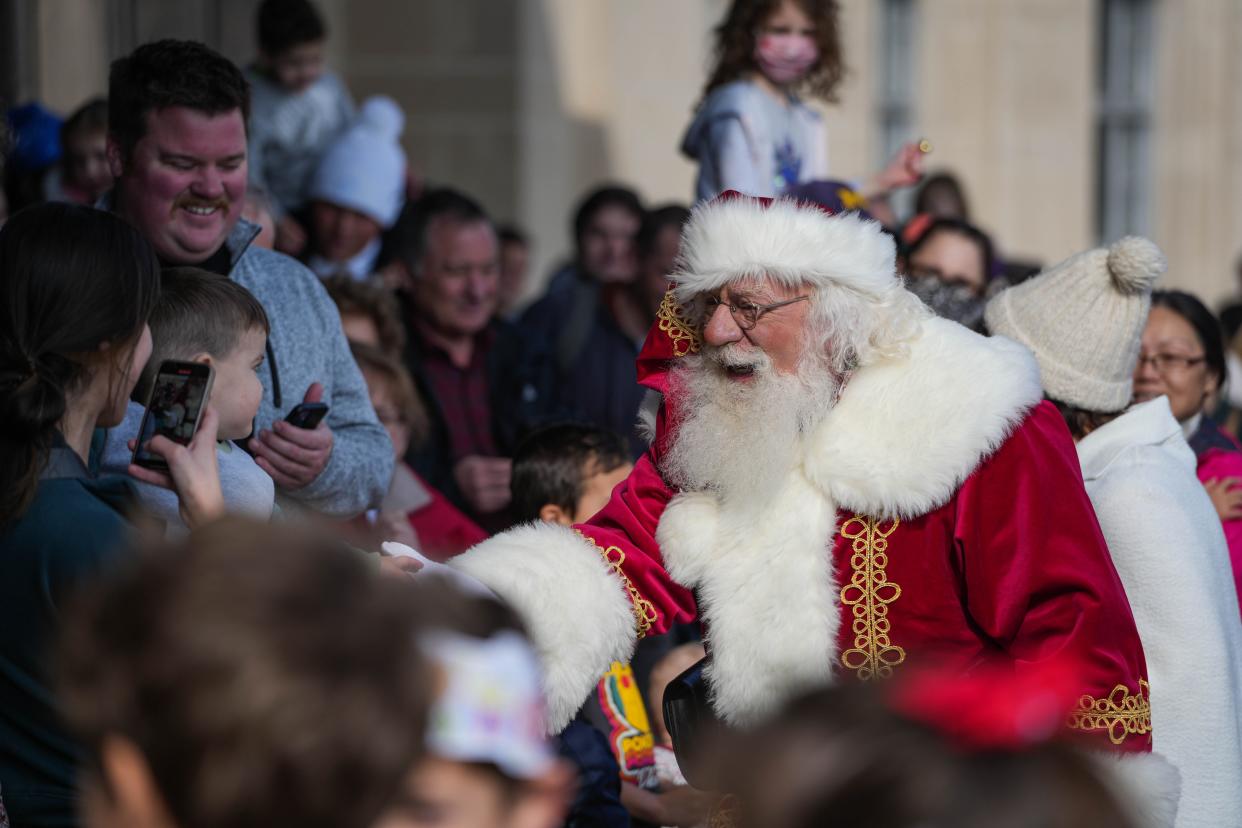 Santa is surrounded by families after arriving at the Cincinnati Museum Center in 2022.