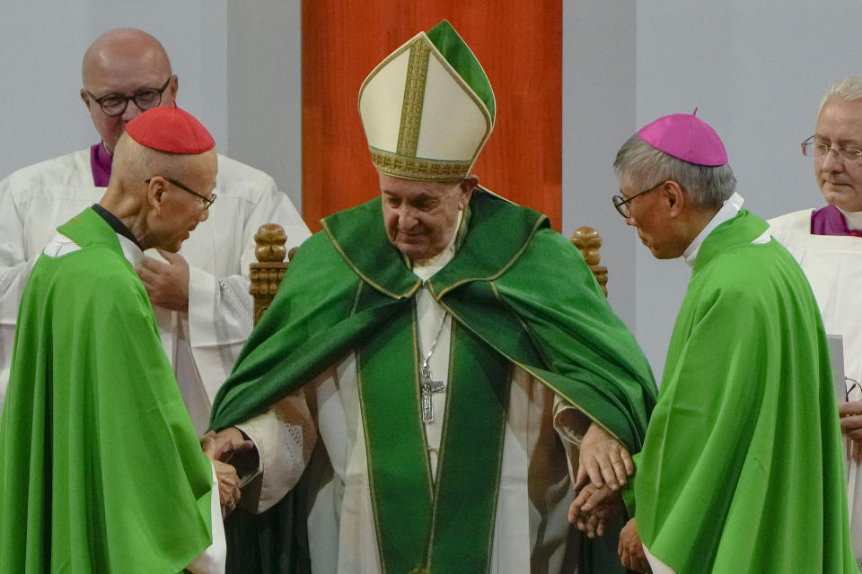 Pope Francis is joined by Cardinal John Tong Hon, left, and Cardinal-elect Stephen Chow, both from Hong Kong after presiding over a mass at the Steppe Arena in the Mongolian capital Ulaanbaatar, Sunday, Sept. 3, 2023. Francis is in Mongolia to minister to one of the world's smallest and newest Catholic communities. Neighboring China's crackdown on religious minorities has been a constant backdrop to the trip, even as the Vatican hopes to focus attention instead on Mongolia and its 1,450 Catholics. (AP Photo/Ng Han Guan)