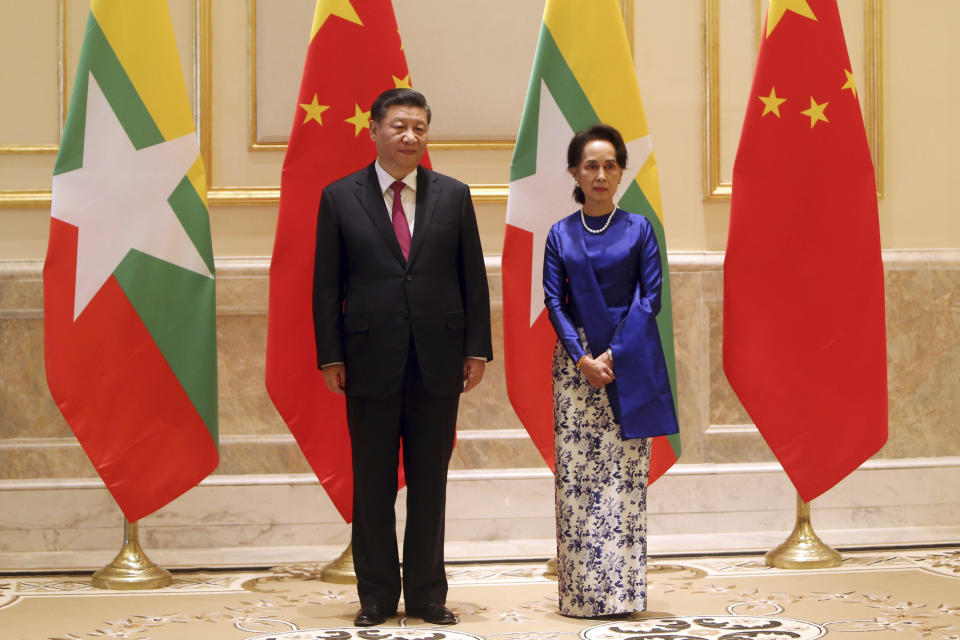 FILE - Myanmar's leader Aung San Suu Kyi, right, and Chinese President Xi Jinping pose for the media during their meeting at the Presidential Palace in Naypyitaw, Myanmar, Jan. 17, 2020. Chinese President Xi has been absent from the Group of 20 summit in Rome and global climate talks in Scotland, drawing criticism from U.S. President Joe Biden and questions about China's commitment to reducing greenhouse gas emissions. Xi hasn't left the country since making a January 2020 trip to neighboring Myanmar. (AP Photo/Aung Shine Oo, File)