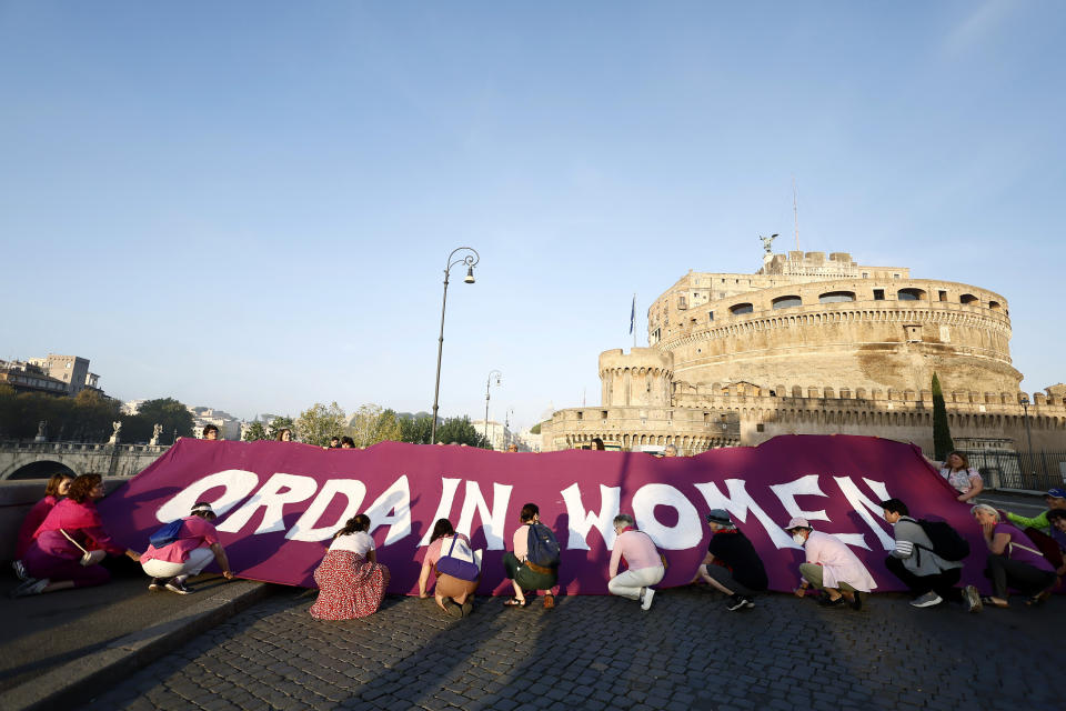 Women hold up a banner during a protest at St Angel Castle by WOC, Women Ordination Conference requesting the ordination of women to the priesthood, as Pope Francis begins a synod presiding over a mass in St. Peter’s Square at The Vatican, Wednesday, Oct. 4, 2023. Pope Francis has opened a big meeting on the future of the Catholic Church. (Cecilia Fabiano /LaPresse via AP)