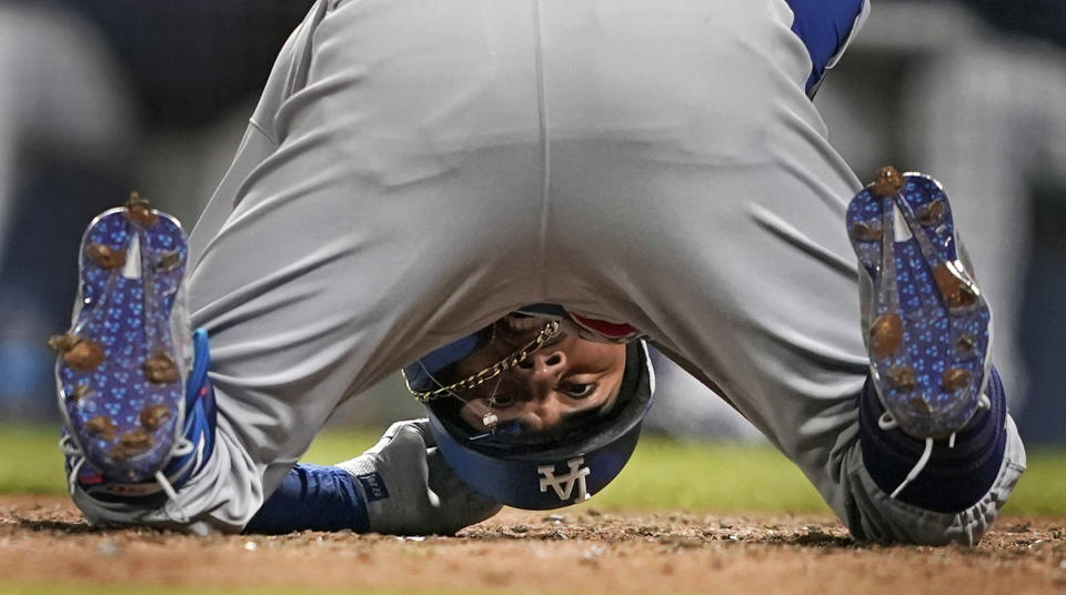Los Angeles Dodgers' Mookie Betts goes down after being hit by a pitch during the ninth inning of a baseball game against the Seattle Mariners, Monday, April 19, 2021, in Seattle. Betts stayed in the game and the Mariners won 4-3. (AP Photo/Ted S. Warren)