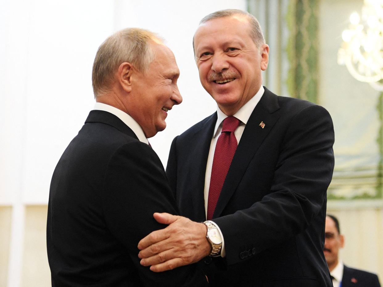 Russia's President Vladimir Putin (L) shakes hands with his Turkey's counterpart Recep Tayyip Erdogan.