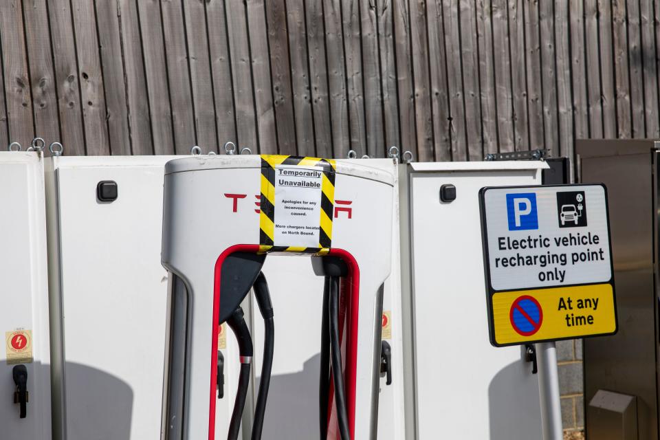 Tesla superchargers for Electric vehicles at Fleet motorway services in Hampshire, signs indicate that the chargers are unavailable for use,England,UK
