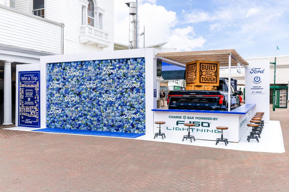 Ford Motor Co. and Churchill Downs Racetrack have a multi-year partnership deal. One aspect of this partnership is Ford's display featuring a flower wall, F-150 Lighting and a phone charging station, in the Paddock Plaza during the Kentucky Oaks and Derby.