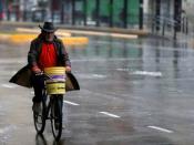 A man rides his bike during a national blackout, in Buenos Aires