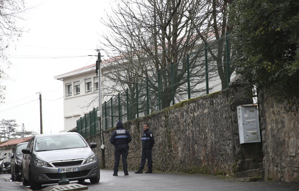 Police officers guard an access to a private Catholic school after a teacher of Spanish has been stabbed to death by a high school student, Wednesday, Feb. 22, 2023 in Saint-Jean-de-Luz, southwestern France. The student has been arrested by police, the prosecutor of Bayonne said. (AP Photo/Bob Edme)