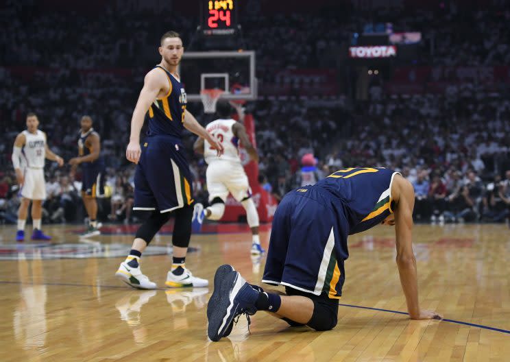 Rudy Gobert needed to be helped off the court by teammates after injuring his knee on the first possession of Game 1 against the Clippers. (AP)